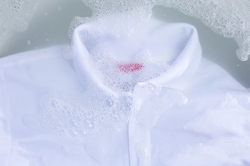 Soak a cloth before washing, white polo shirt. Top view