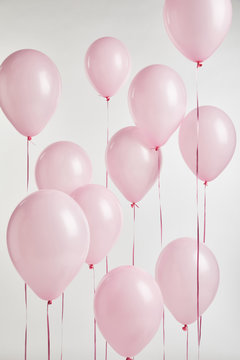 Fototapeta background with decorative pink air balloons isolated on white