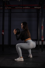 Fototapeta na wymiar Attractive asian woman doing exercises with a medicine ball. Asian athlete girl doing exercise working out with heavy weighted ball.