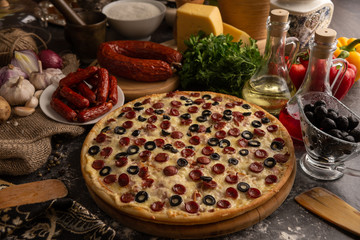 Pizza with hunting sausages and olives