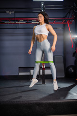 Fototapeta na wymiar Resistance band exercises with fabric elastic equipment. Asian fitness woman