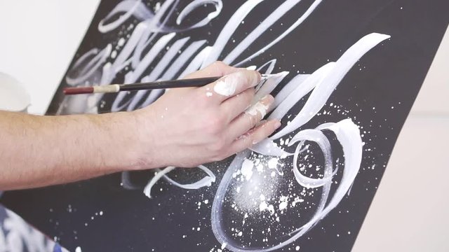 Slow motion, modern artist draws a picture, close-up.