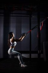 Asian girl learning hard workout.  asian woman training with trx straps in the gym