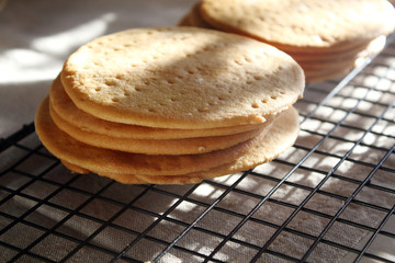 A stack of biscuits shortbread cookies pancake cakes for russian layered honey cake on cooling rack