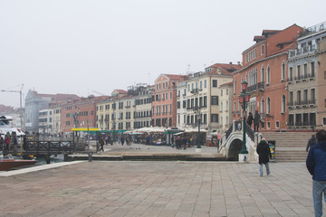 Venice / Italy 19 february 2019 :Snapshot of the river the people and the houses by the canal,traditional building and the bridge that connects the street to the other side