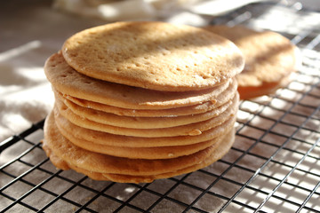 A stack of biscuits shortbread cookies pancake cakes for russian layered honey cake on cooling rack