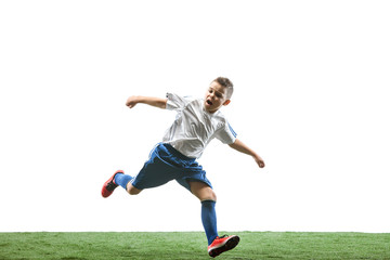Obraz na płótnie Canvas Young boy running and jumping isolated on white studio background. Junior football soccer player in motion