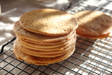 A stack of biscuits shortbread cookies pancake cakes for russian layered honey cake on cooling rack