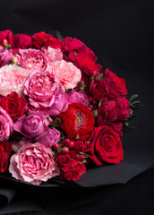 a large bouquet, a lot of red and pink roses, a gift, black packaging