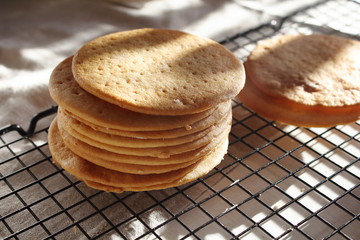 A stack of biscuits shortbread cookies pancake cakes for russian layered honey cake on cooling rack