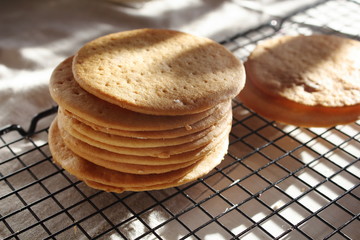 A stack of biscuits shortbread cookies pancake cakes for russian layered honey cake on cooling rack