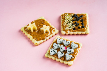 Delicious Toast with peanut butter on the pink background