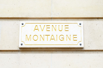 Famous Avenue Montaigne street sign in golden letters in Paris, France