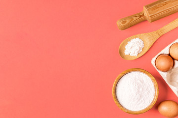 Ingredients and utensils for baking on a pastel background.