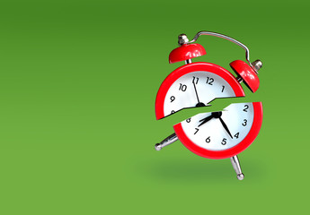 Waste of time concept with alarm clock broken in half