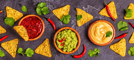 Mexican food background: guacamole, salsa, cheesy sauces