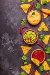 Mexican food background: guacamole, salsa, cheesy sauces
