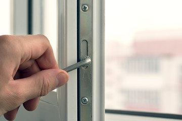 Workman adjusts the operation of the plastic window.