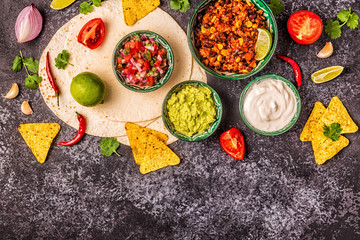 Mexican food concept: tortillas, nachos with guacamole, salsa.