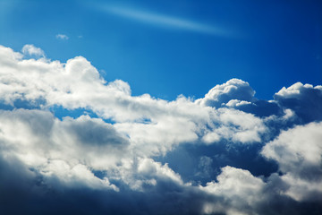 Obraz premium Background of transparent white clouds in a light blue sky illuminated by the sun.