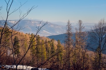Fototapeta na wymiar Beautiful winter mountain landscape. Sunny day on the trail in the Polish mountains.
