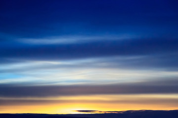 Sunset transparent blue clouds in the dark sky. Background from dramatic cloudy sky.