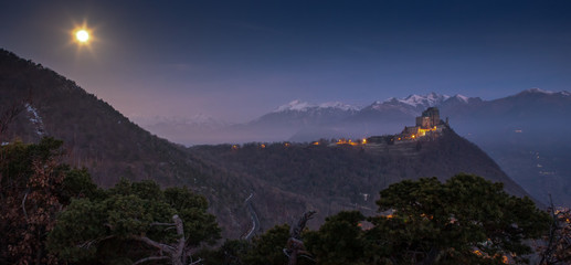 Sacra di San Michele or Saint Michael's Abbey and the alps, Piedmont, Italy in the night during a...