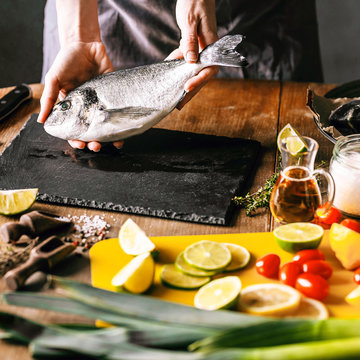 Woman Chef Preparing Fresh Raw Dorado Fish