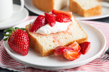 Angel food cake with whipped cream and strawberries