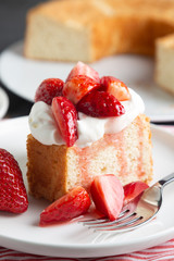 Angel food cake with whipped cream and strawberries