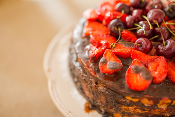 Closeup chocolate cake with fresh strawberry on rustic background