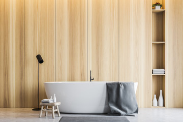 Light wooden bathroom interior, tub and shelves