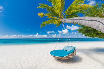 Tropical beach background as summer landscape with beach swing or hammock and white sand and calm...