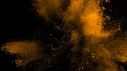 Super slowmotion shot of golden powder explosion isolated on black background.