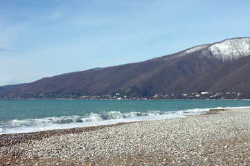 Empty beach in winter against a background of mountains, Gagra, Abkhazia