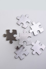 Obraz premium metal puzzle on a white background