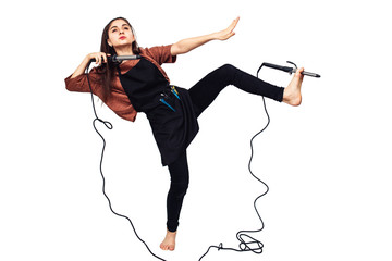 young girl hairdresser with curling iron.