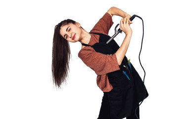 young girl hairdresser with curling iron.