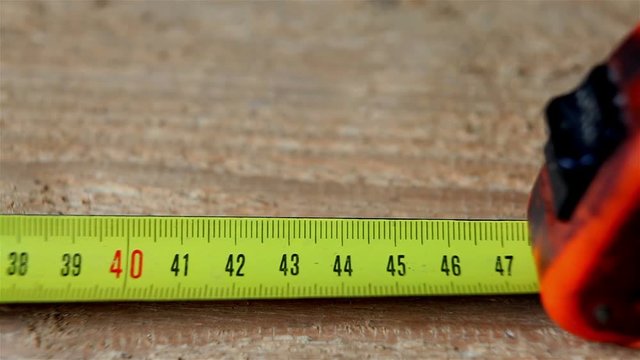 Metal tape measure the length of the board.