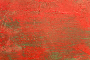 old shabby green blue wall with stains of red paint, cracks and scratches. rough surface texture
