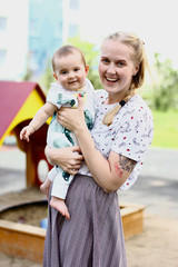 Young mother with a baby in her arms