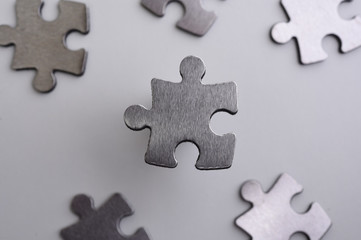 Obraz premium metal puzzle on a white background