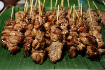 Grilled pork on a banana leaf.