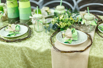 Served table at restaurant. Preparation for banquet. Restaurant table decoration for festive event. Green color