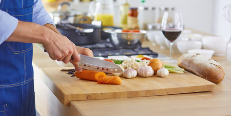 Young chef prepares a man in the kitchen