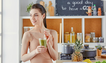 a young girl drinks a cocktail on a kitchen