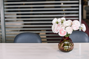 Lovely flowers in glass vase. Beautiful bouquet of pink persian buttercup.