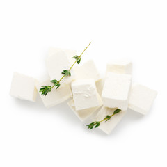 Pile of greek cheese cubes on white
