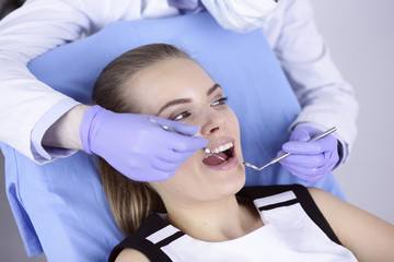 Fototapeta premium beautiful girl in the dental chair on the examination at the de
