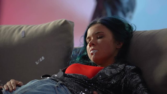Rave drug overdose, unconscious junkie girl mouth foaming at nightclub party